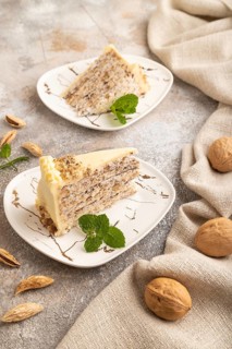 Walnut and almond cake on brown concrete background and linen textile. side view, close up