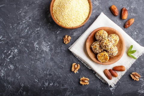 Energy ball cakes with dried apricots, sesame, cornflakes, linen, walnuts and dates with green mint