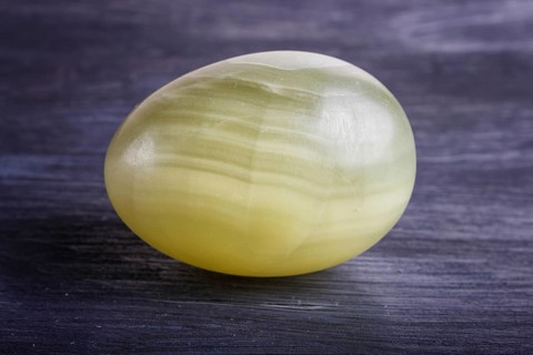 Green onyx egg on a black background, close up