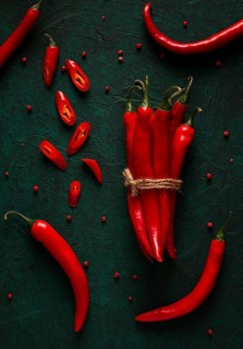 Bunch of red hot chili pepper, close-up, on a dark background, selective focus, no people, concept,