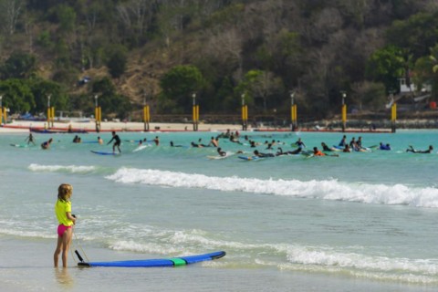 Girl on the beach in a surf school, water sports, beach, sea, ocean, sport, holiday, travel,