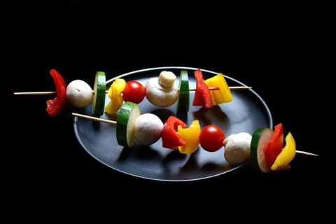 Colourful vegetable skewers on a plate, barbecue skewers