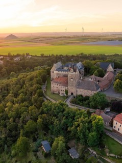 Bird's eye view of the castle with surrounding forests and fields at sunset, Allstedt, Harz,