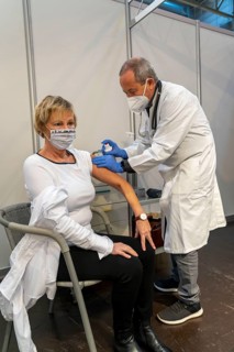 Vaccinator administers a vaccination, during the test run in the vaccination centre for corona