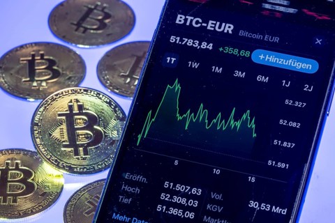 Bitcoin cryptocurrency, symbol coin, mobile phone, mobile phone with Bitcoin exchange rates, to the
