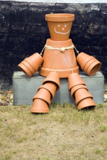 Flowerpot man sitting on metal tub, England, UK