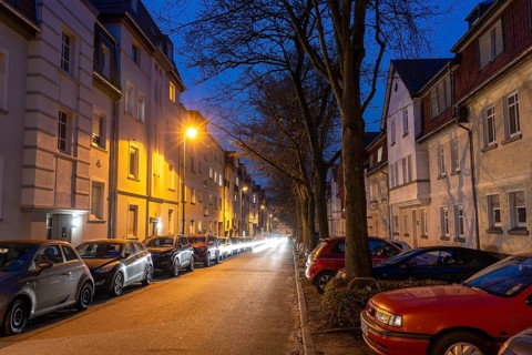 Residential street, many apartment buildings in a residential neighbourhood, evening, lantern