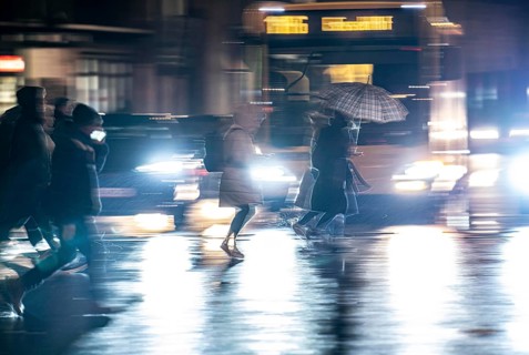 Passers-by at a pedestrian crossing, at the main railway station, rainy weather, city centre, in