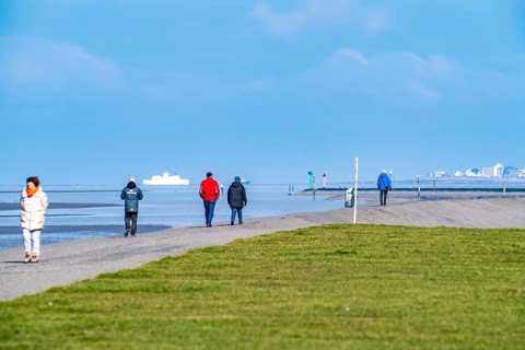 Dyke walk on the East Frisian coast near Norddeich, in the background the island of Norderney,
