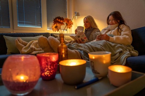 Symbolic image energy saving, cold winter, energy crisis, cold flat, mother and daughter lying on