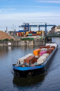 Container freighter Aarburg, leaving the container terminal in Frankfurt Osthafen, belonging to