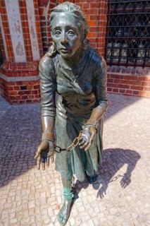 Grete-Minde monument in front of the historic town hall in the old town centre of Tangermünde. The