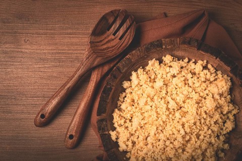 Cooked couscous, in a wooden bowl, top view, no people
