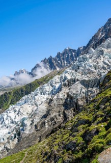 Glacier ice of the Glacier des Bossons, behind pointed mountain peaks, Chamonix, Haute-Savoie,
