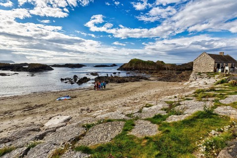 Rocky coast with narrow sandy beach, Ballintoy Harbour, Causeway Coastal Route, Antrim, Northern