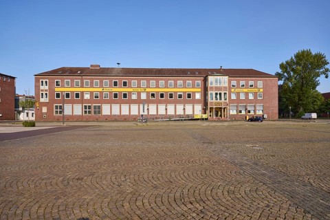 Former post office, blue cloudless sky, tree, town hall square, Wilhelmshaven, independent city,