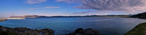 Panoramic view of a coastal landscape with calm sea and cloudy sky in the background, Gulf of