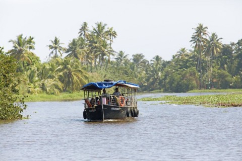 Traditional boat on a canal in the canal system of the backwaters, Kerala, India, Asia