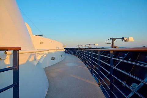 Deck of a cruise ship with clear blue sky and blue railing, Mein Schiff 6, North Sea, Denmark,