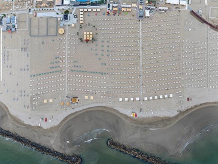 Bathing beach in Rimini. Bathing beach on the Adriatic in bad weather. All deckchairs are free.
