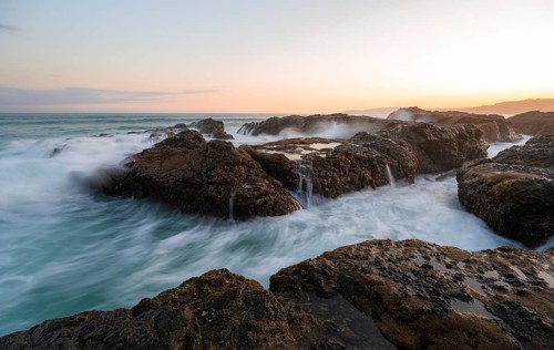 Waves washing over rocks by the sea, long exposure, coastal landscape at sunset, Playa Cocalito,