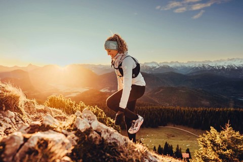 Trail running in autumn on the Jochberg on Lake Walchensee against the wonderful backdrop of the
