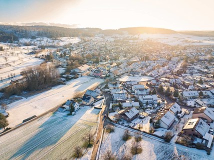 Winter village at dusk with snow-covered roofs and fields in soft light, Calw- Stammheim, Black