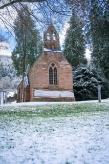 A snow-covered church surrounded by trees under a clear sky, English Church, spa garden, Bad