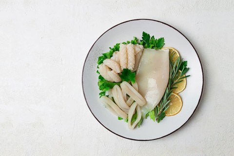 Fresh squid, raw, carcass, cut into rings, top view, no people