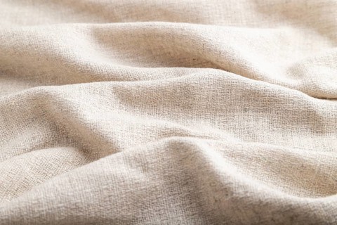 Fragment of white linen tissue. Side view, natural textile background and texture. wave concept,