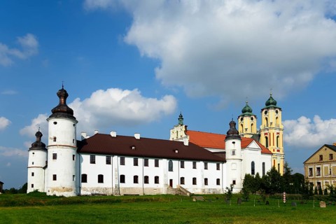 Dominican monastery with white walls and baroque towers under a cloudy sky, Sejny, Podlaskie,