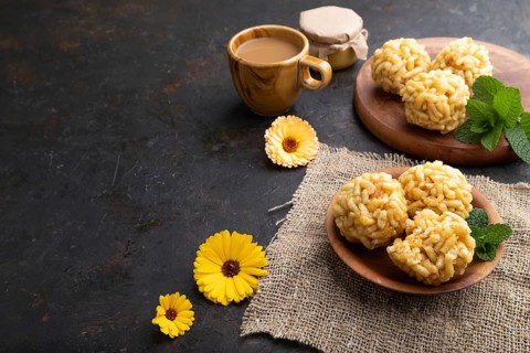 Traditional Tatar candy chak-chak made of dough and honey with cup of coffee on a black concrete