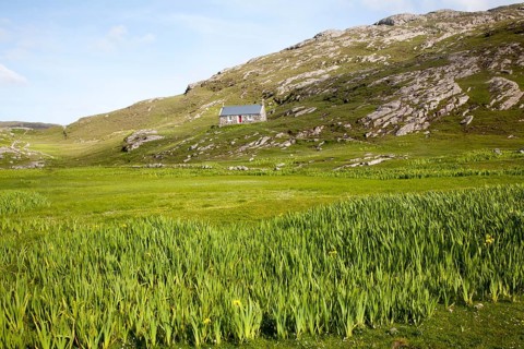 Small boffey building in rocky setting, at Allathasdal, Barra, Outer Hebrides, Scotland, UK