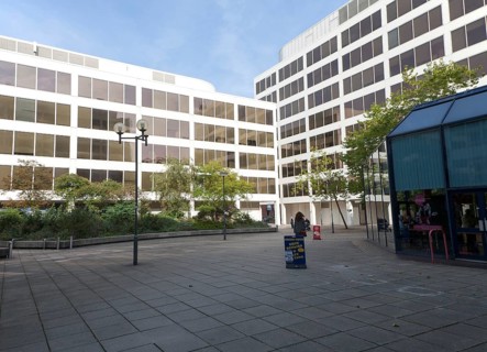 Modern architecture people walking between insurance company offices in the Tricentre development
