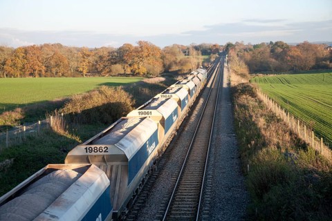 Open waggons of freight train on the West Coast mainline at Woodborough, Wiltshire, England, UK