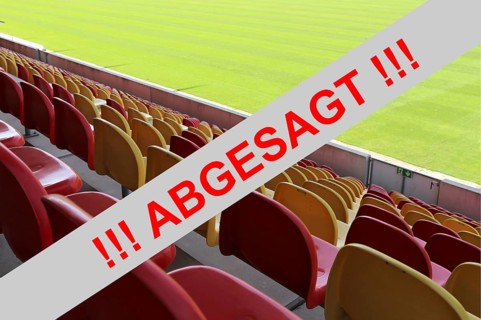 Symbolic image: Red sign with the message (event) cancelled with an empty stadium in the background