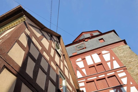 Bell tower of the Protestant church and half-timbered house, view upwards, Runkel, Westerwald,