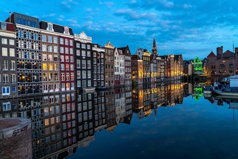 Canal houses on the Damrak, in the centre of the old town of Amsterdam, harbour, starting point of