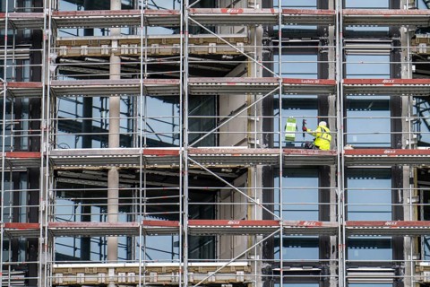 Large construction site, construction of a residential building with many flats, scaffolding,