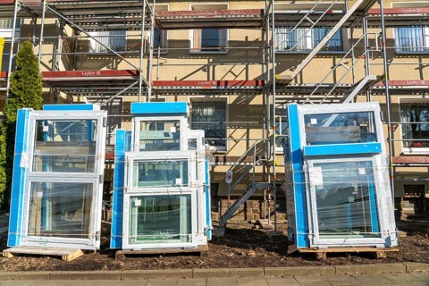 Energy-efficient refurbishment of residential buildings, older apartment block is scaffolded, gets