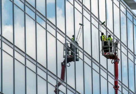 Window cleaner, building maintenance, facade cleaning, on a cherry picker, in Düsseldorf, North