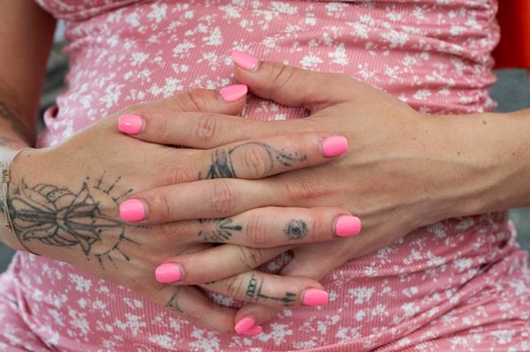 Hands of a young woman with painted nails and tattoos on her fingers, Bavaria, Germany, Europe