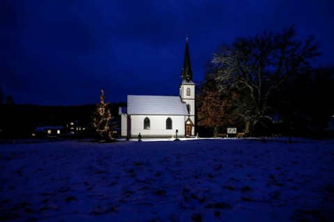 A Christmas tree stands in front of the smallest wooden church in Germany, Elend, 29 December 2020