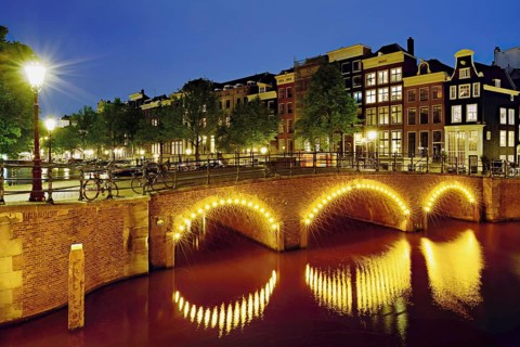 Seven bridges illuminated with neon lights at the corner of Keizersgracht and Reguliersgracht,