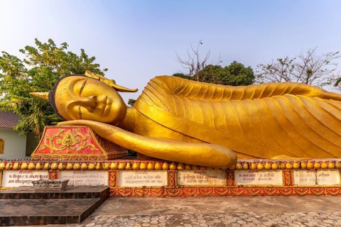 Giant reclining Buddha at Wat That Khao temple in the capital Vientiane, Laos, Asia