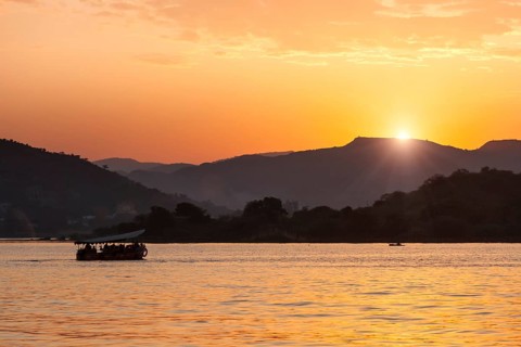Tourist boat in lake Pichola on sunset. Udaipur, Rajasthan, India, Asia