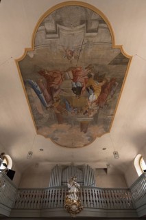 Ceiling painting and the figure of St. Nepomuk in front of the organ loft in the parish church of