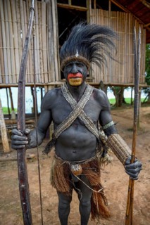 Chief of the village Mutin with bow and arrow, Lake Murray, Western Province, Papua New Guinea,