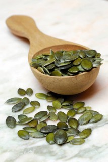 Pumpkin seed in wooden spoon (Cucurbita spec.)