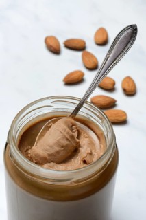 Almond cream in jar with spoon, almond spread